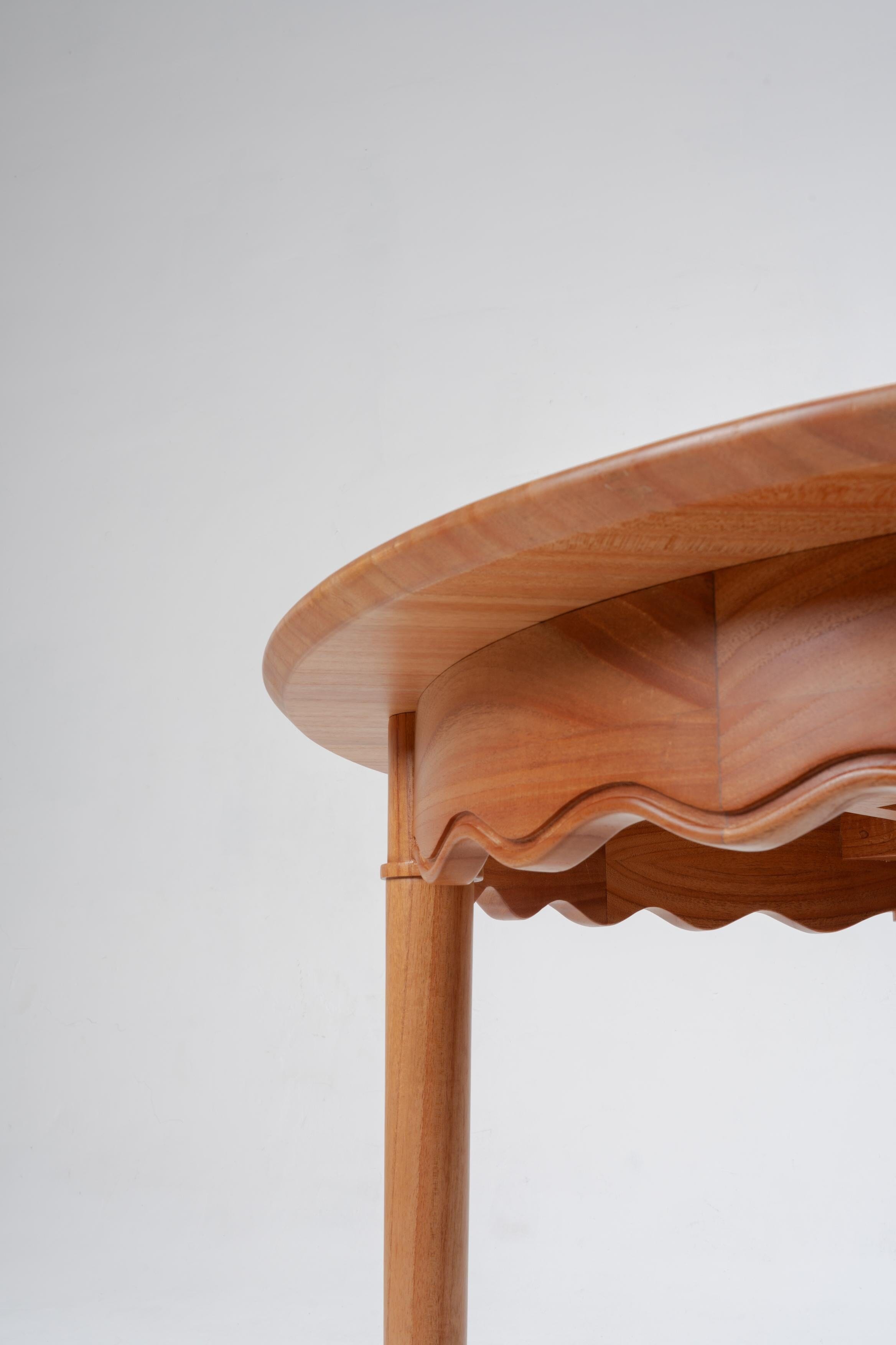 light wooden side table with scalloped edge