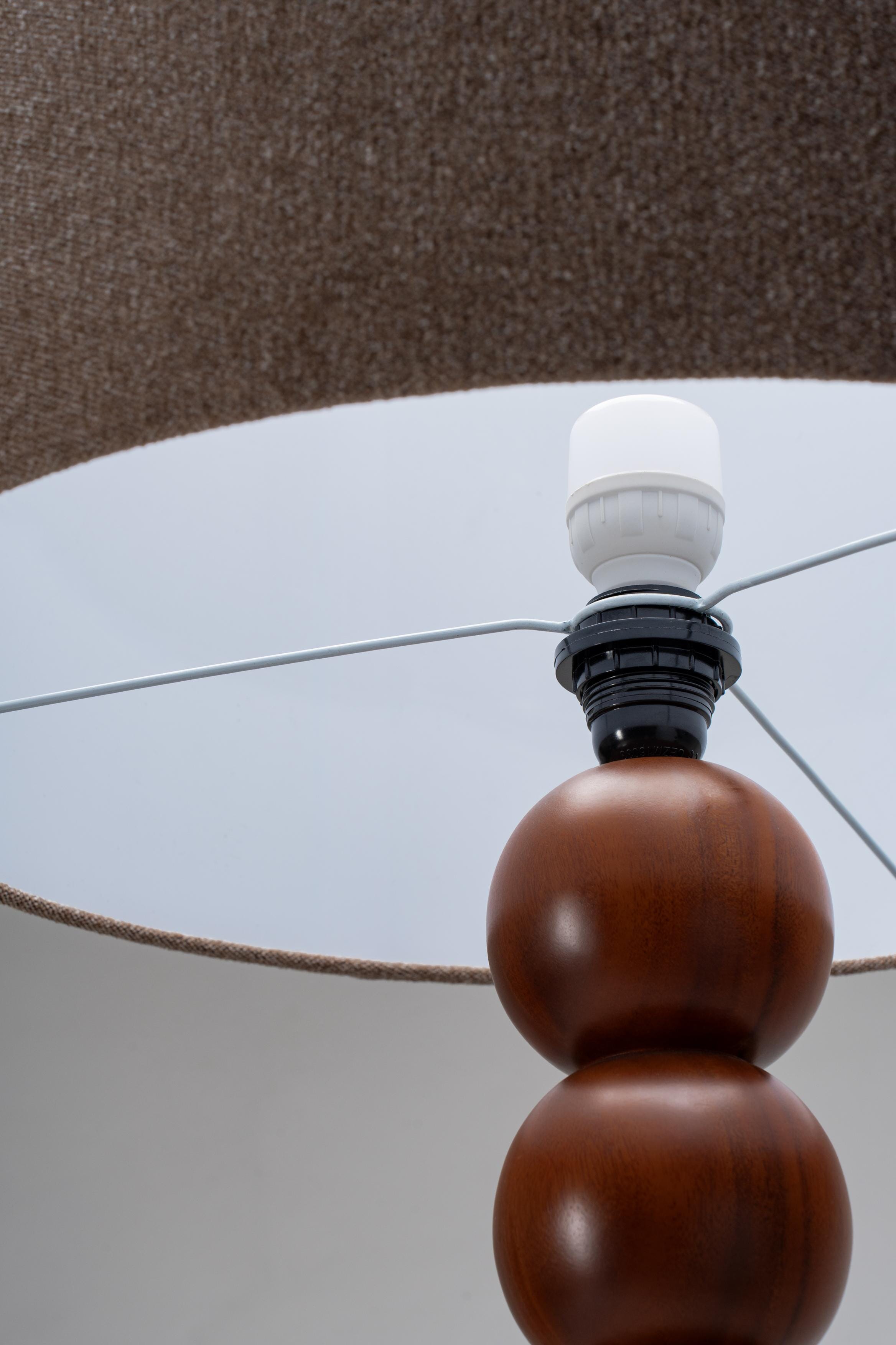 Close-up of a lamp with wooden base and brown lamp shade