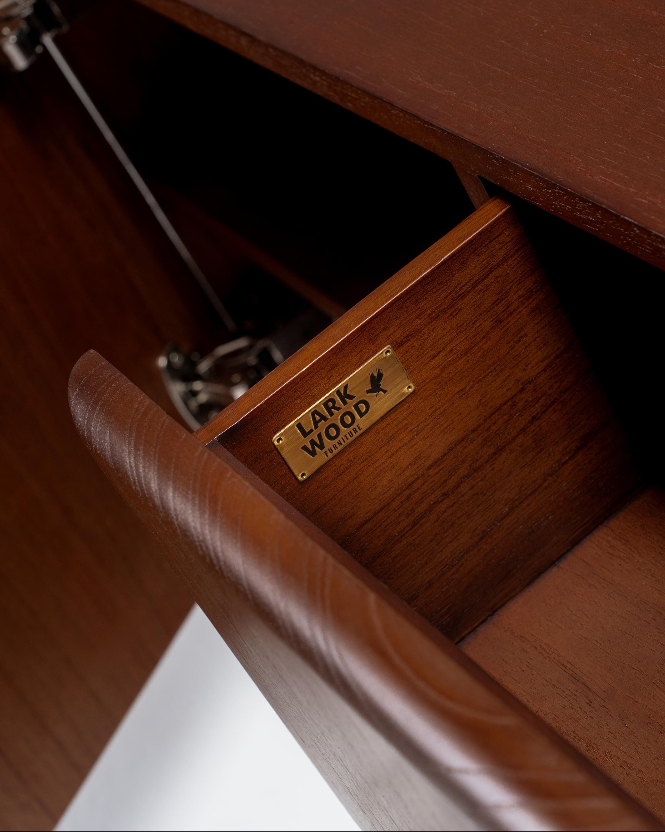 Wooden drawer with 'Lark Wood' label on a wooden cabinet.