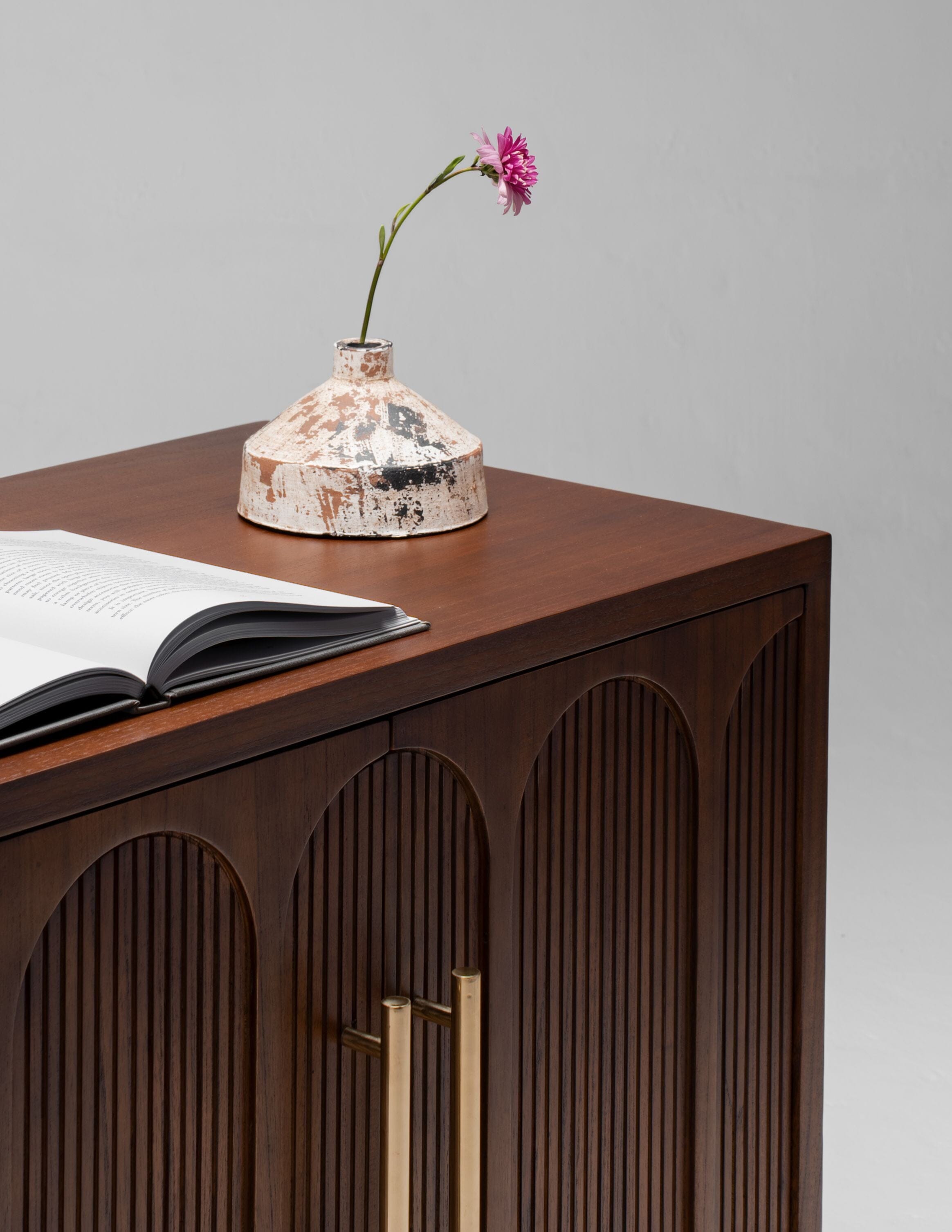 close up of dark wooden bedside table with decoration