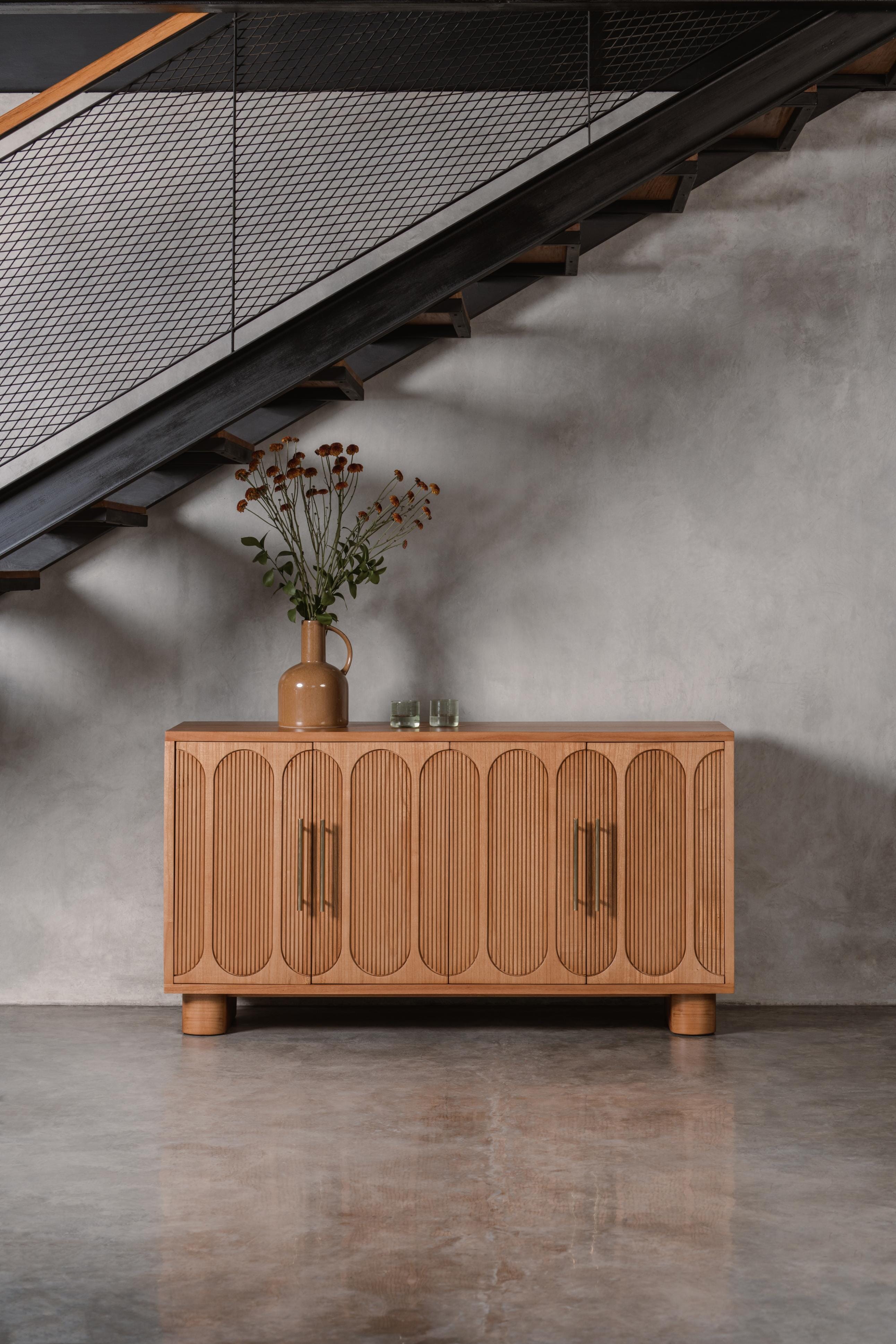 light wooden sideboard with decorative doors and brass handles