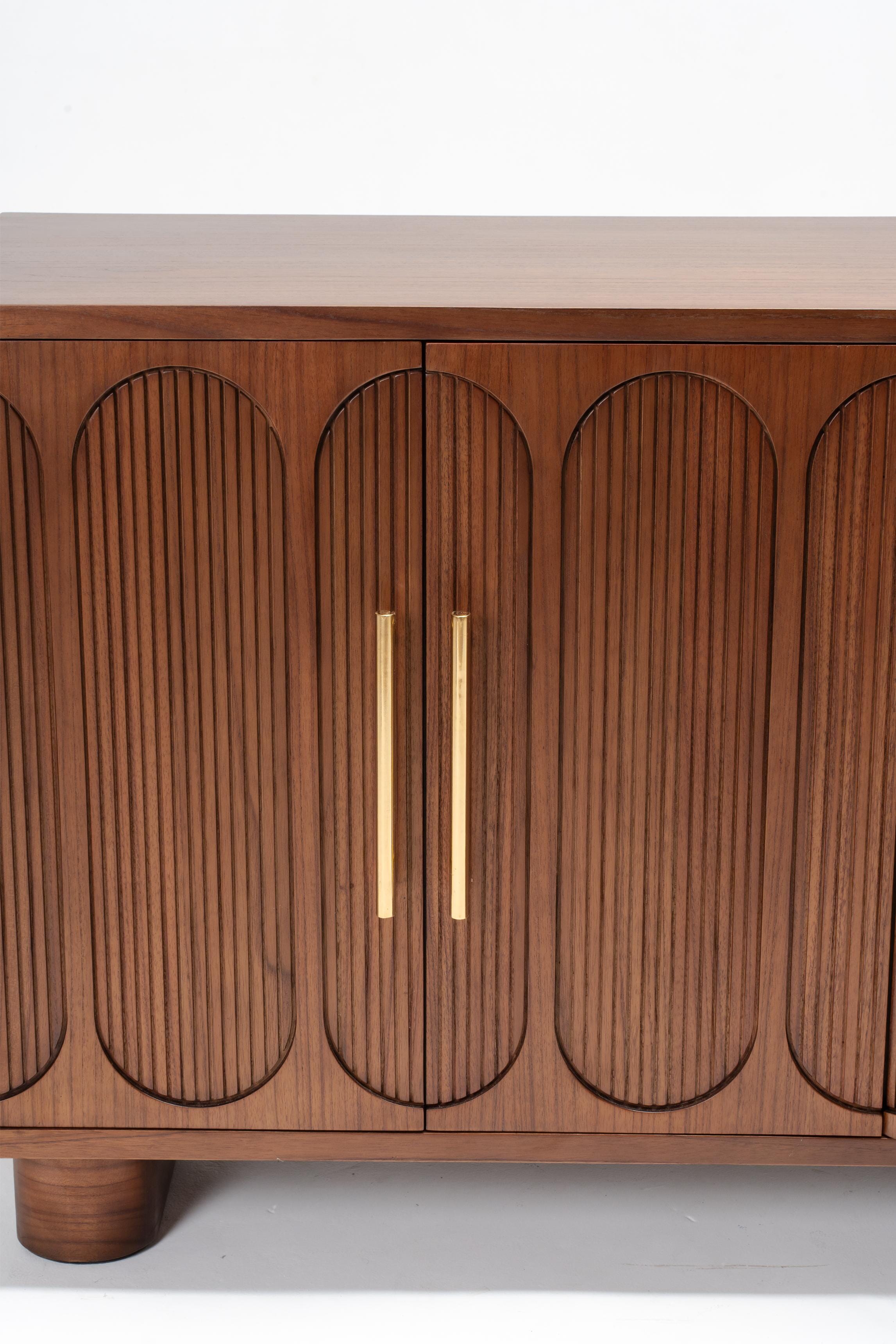 brass handles on large dark wood buffet with doors