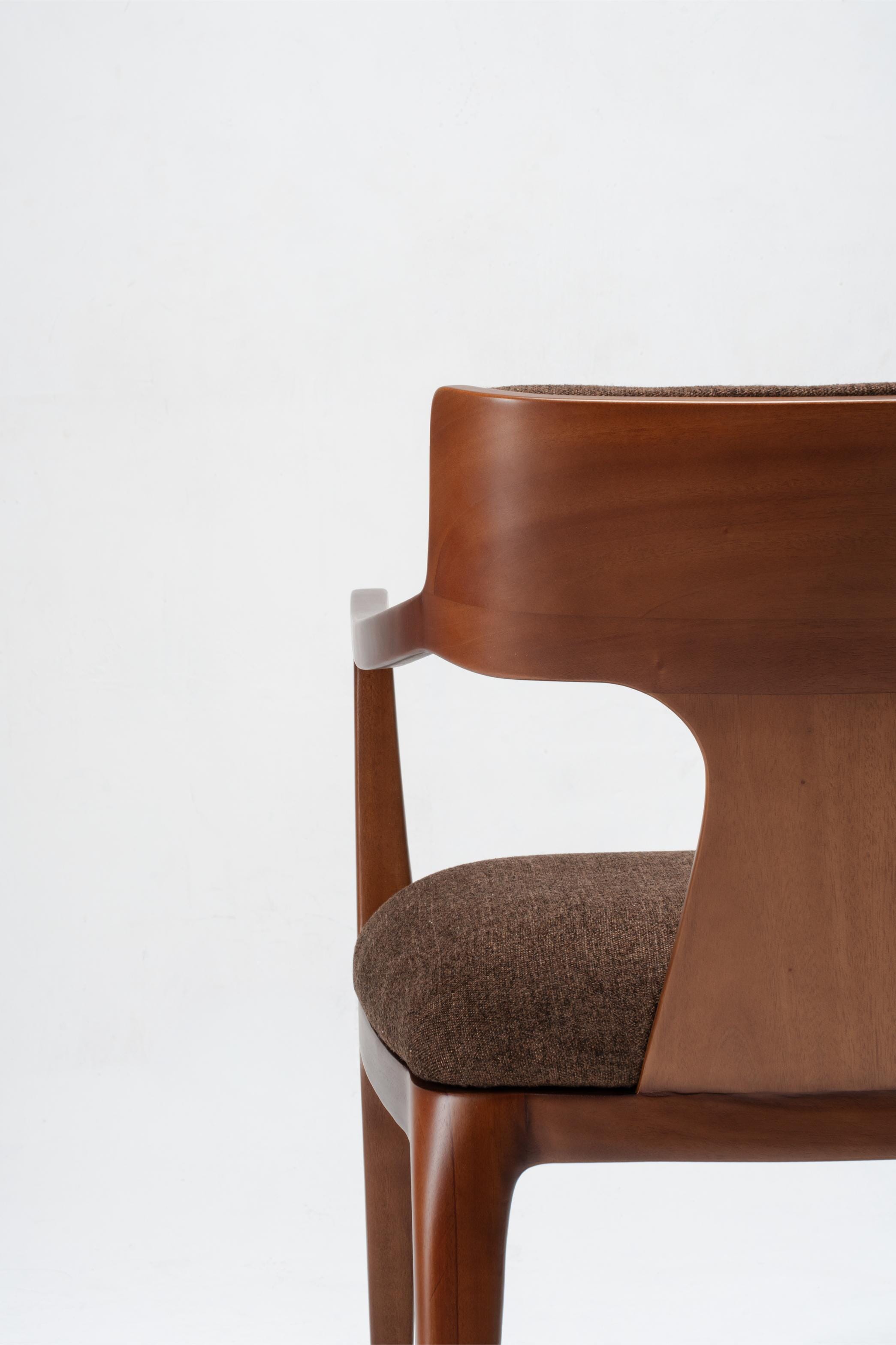 Brown wooden chair with a textured fabric