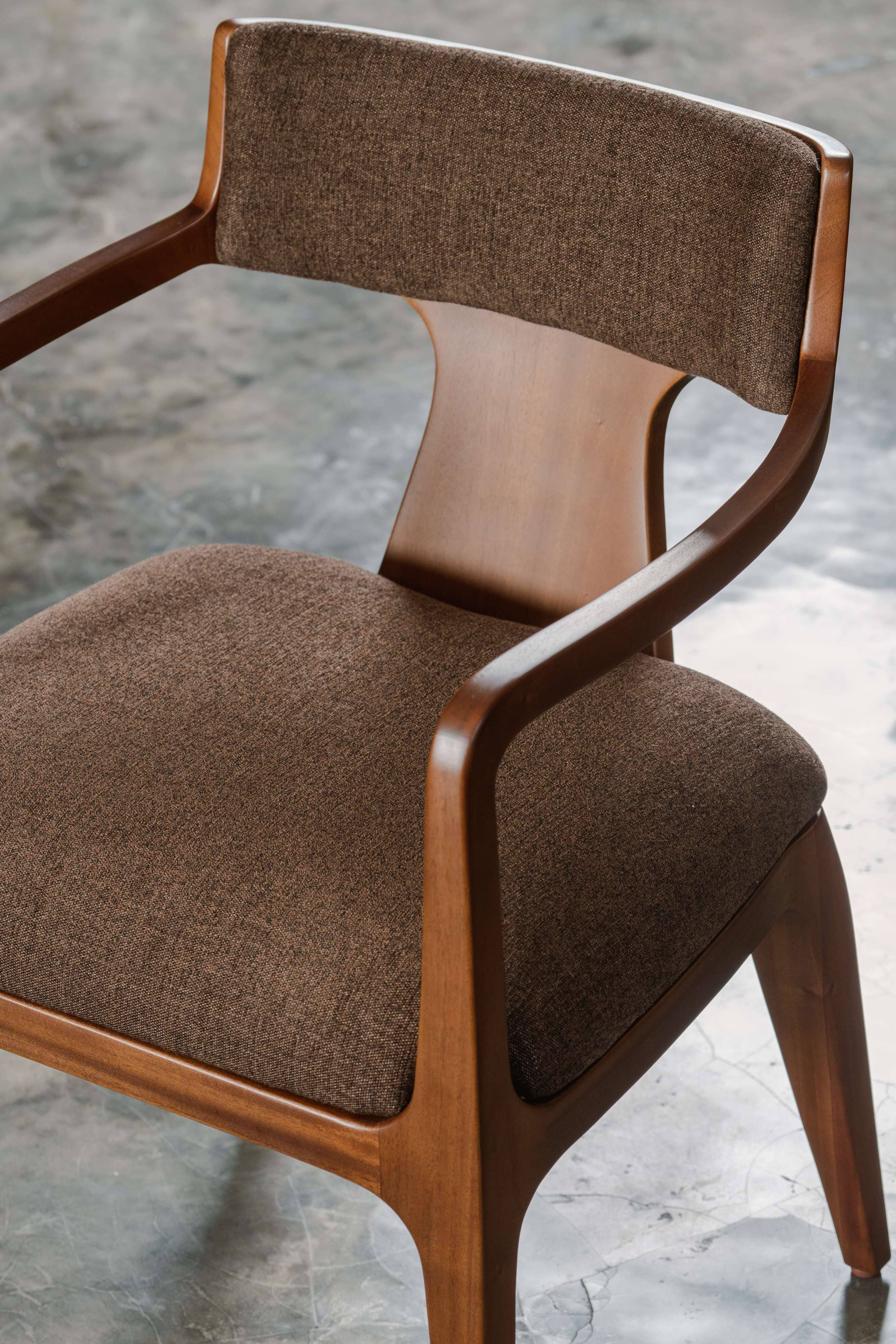 Brown fabric upholstered chair with wooden frame