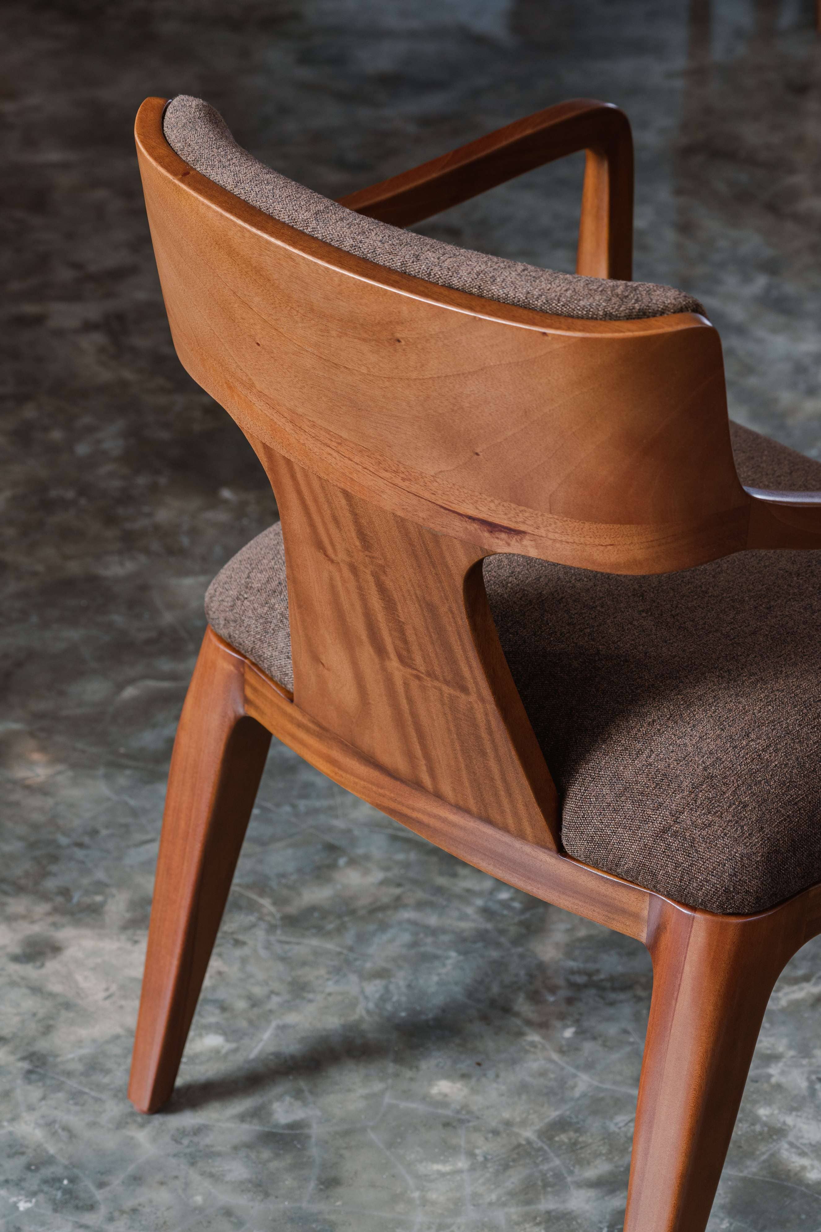 dark mahogany wood dining chair with brown fabric cushioned seat and backrest