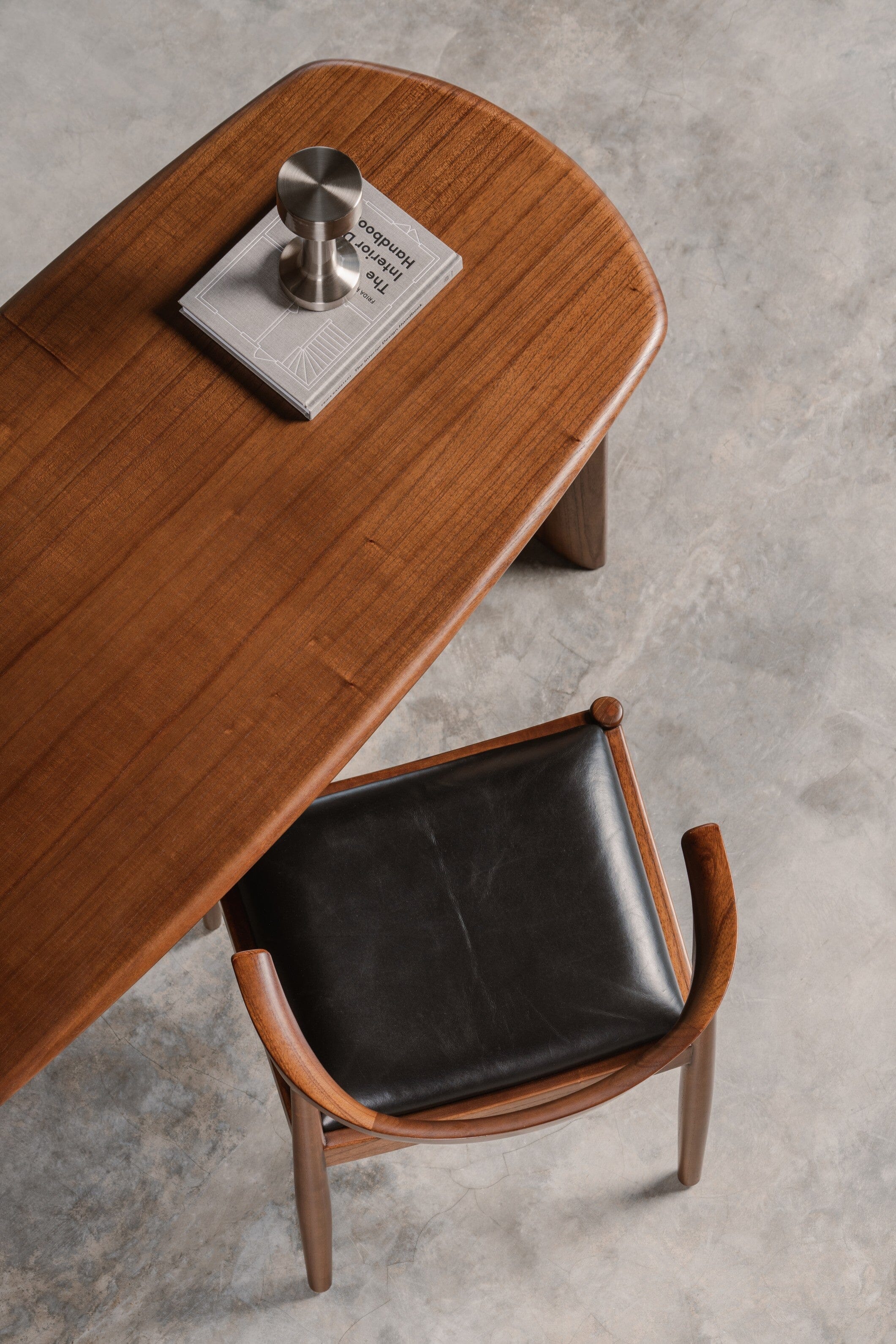 Wooden desk with a leather seat black chair
