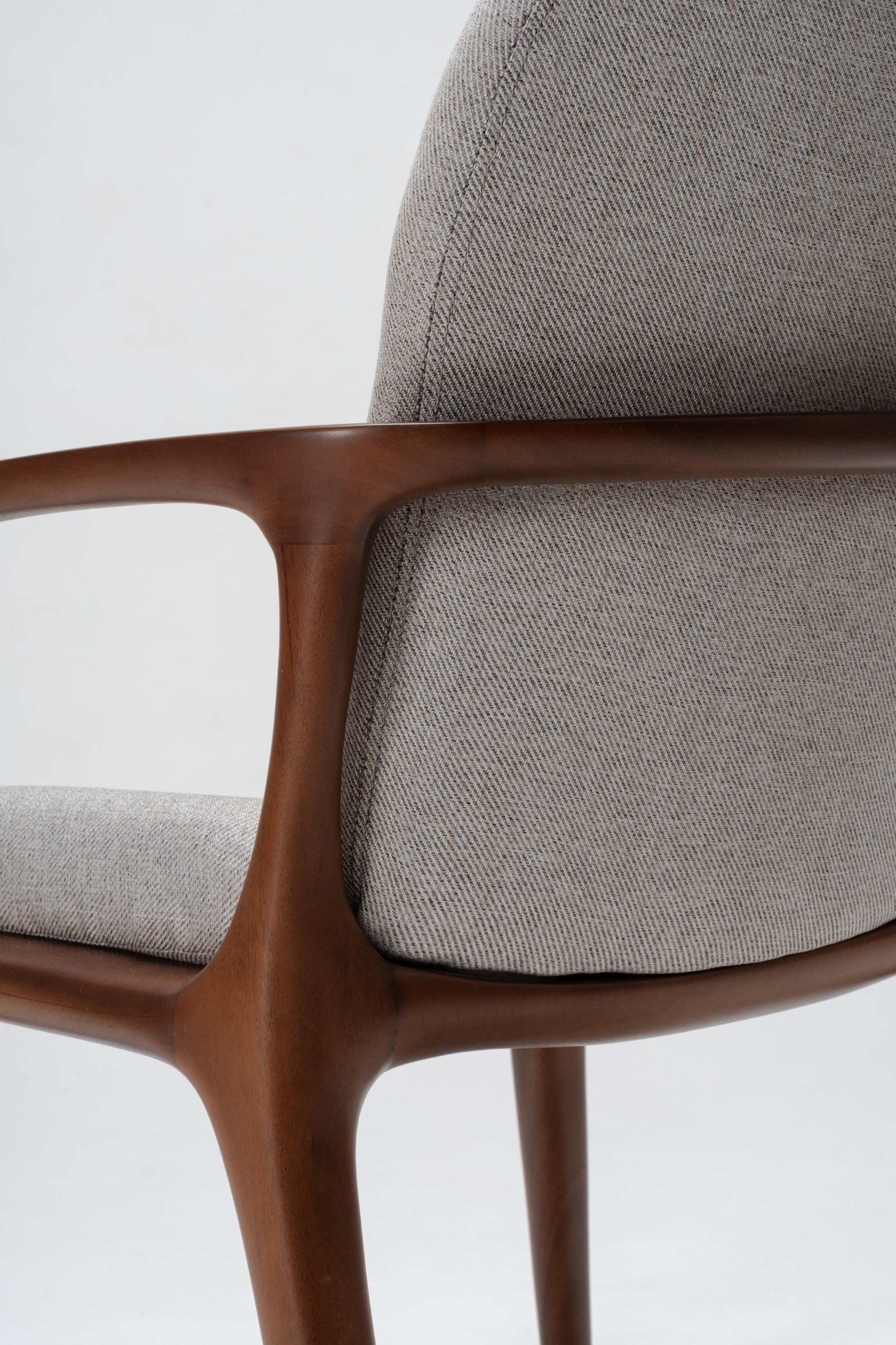 grey upholstered dining chair, detailed woodworking on solid mahogany wood
