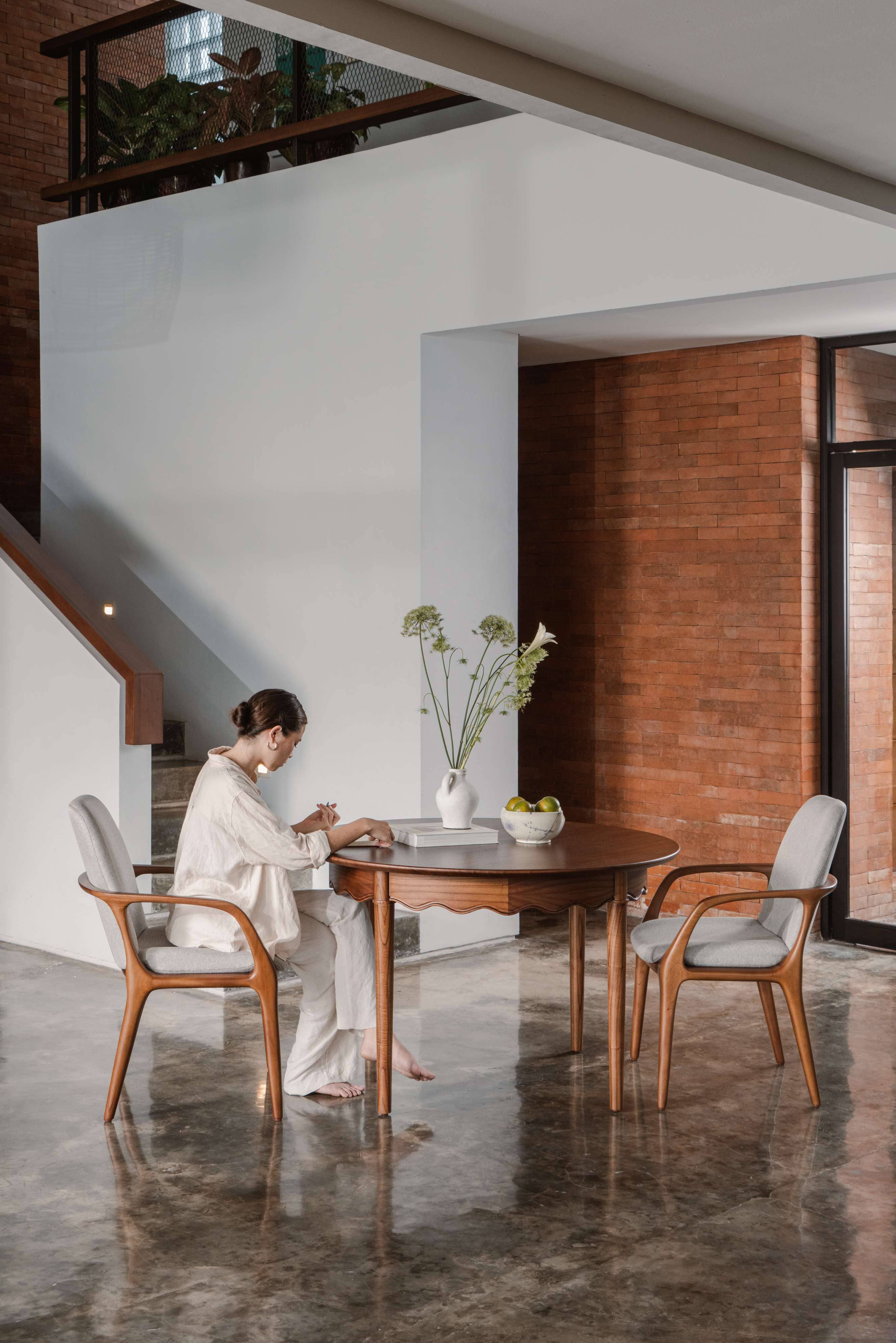 2 grey fabric dining chair with arms and solid wood dining table