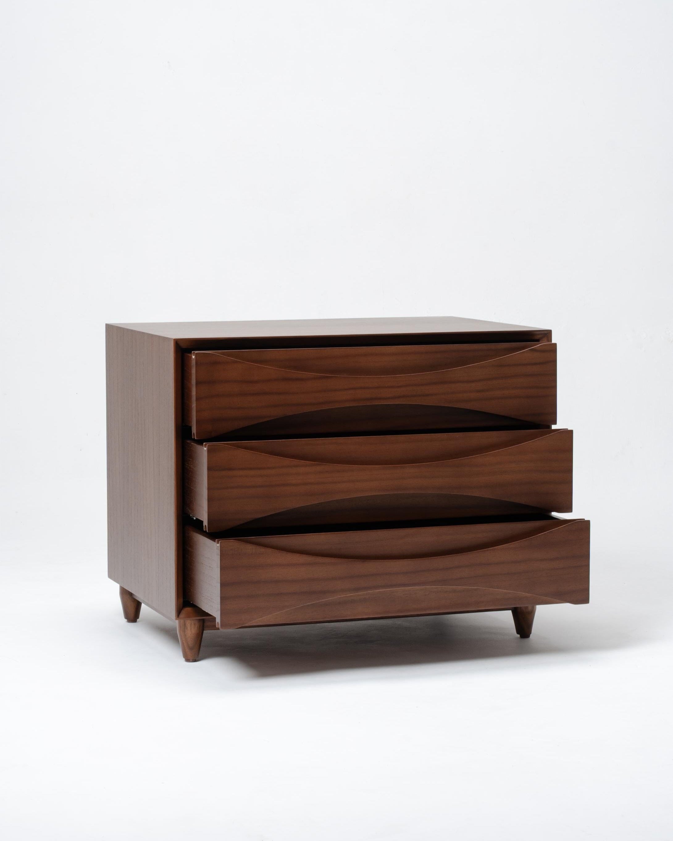 Wooden dresser with three drawers on a white background