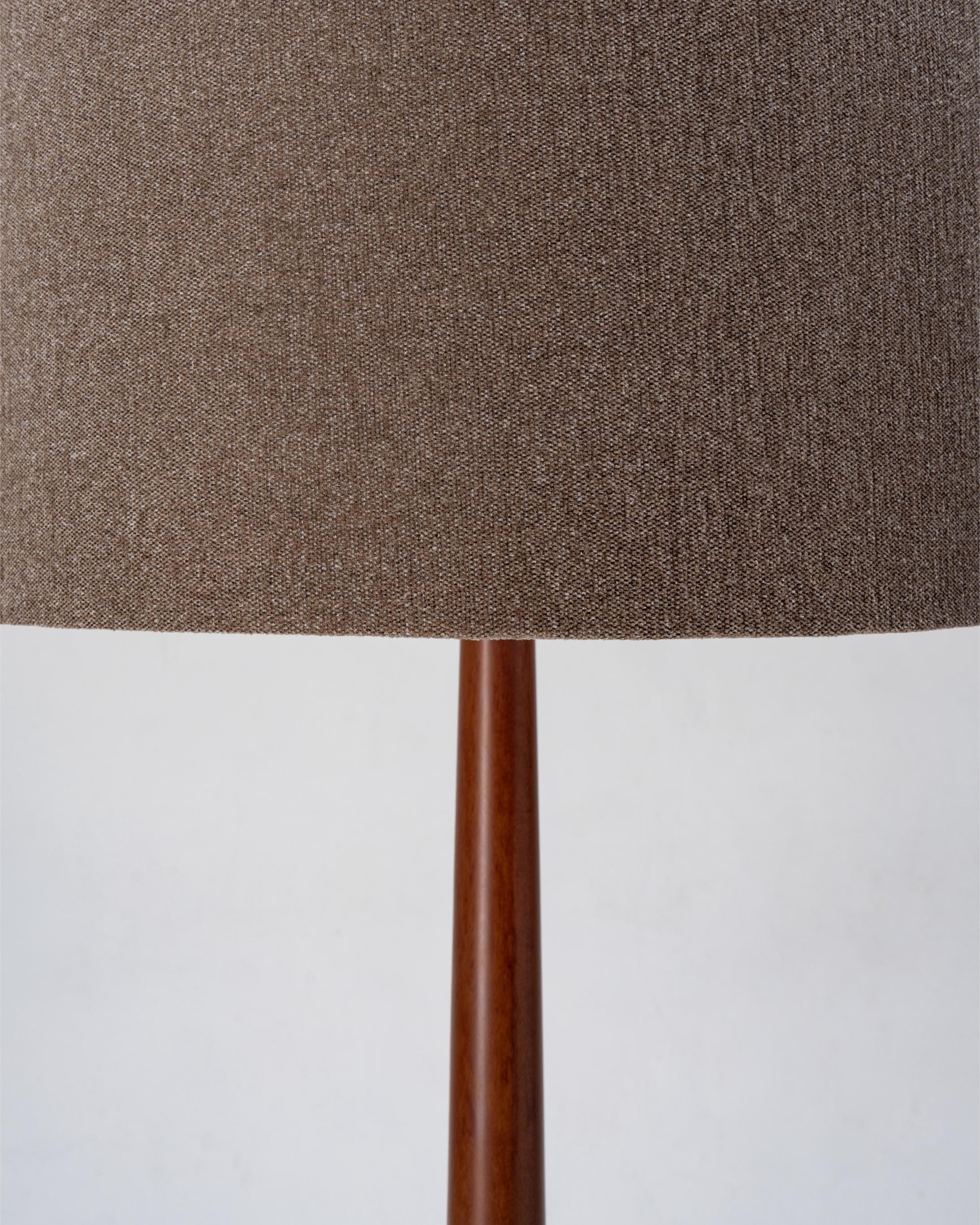Close-up of a lamp with a brown fabric shade and wooden base