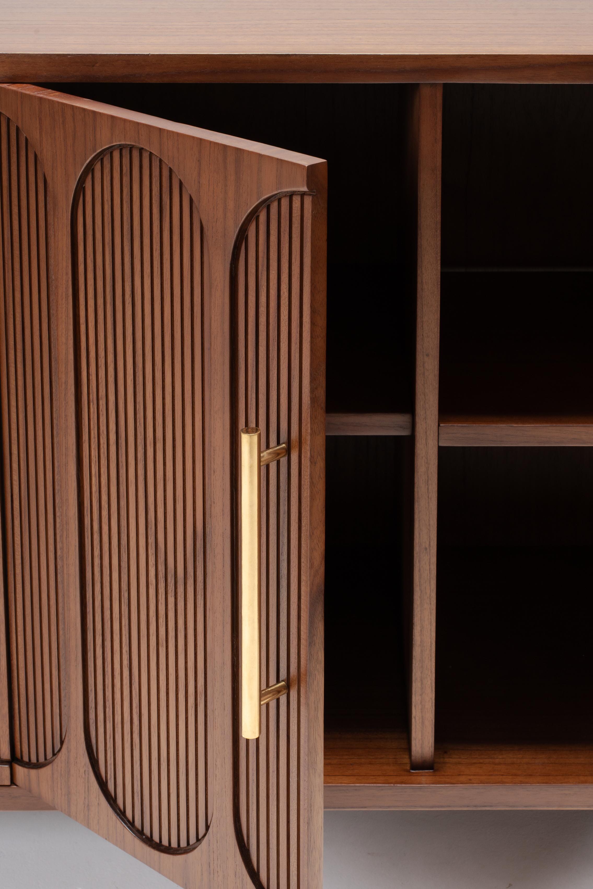 Wooden cabinet with large brass handles and shelves