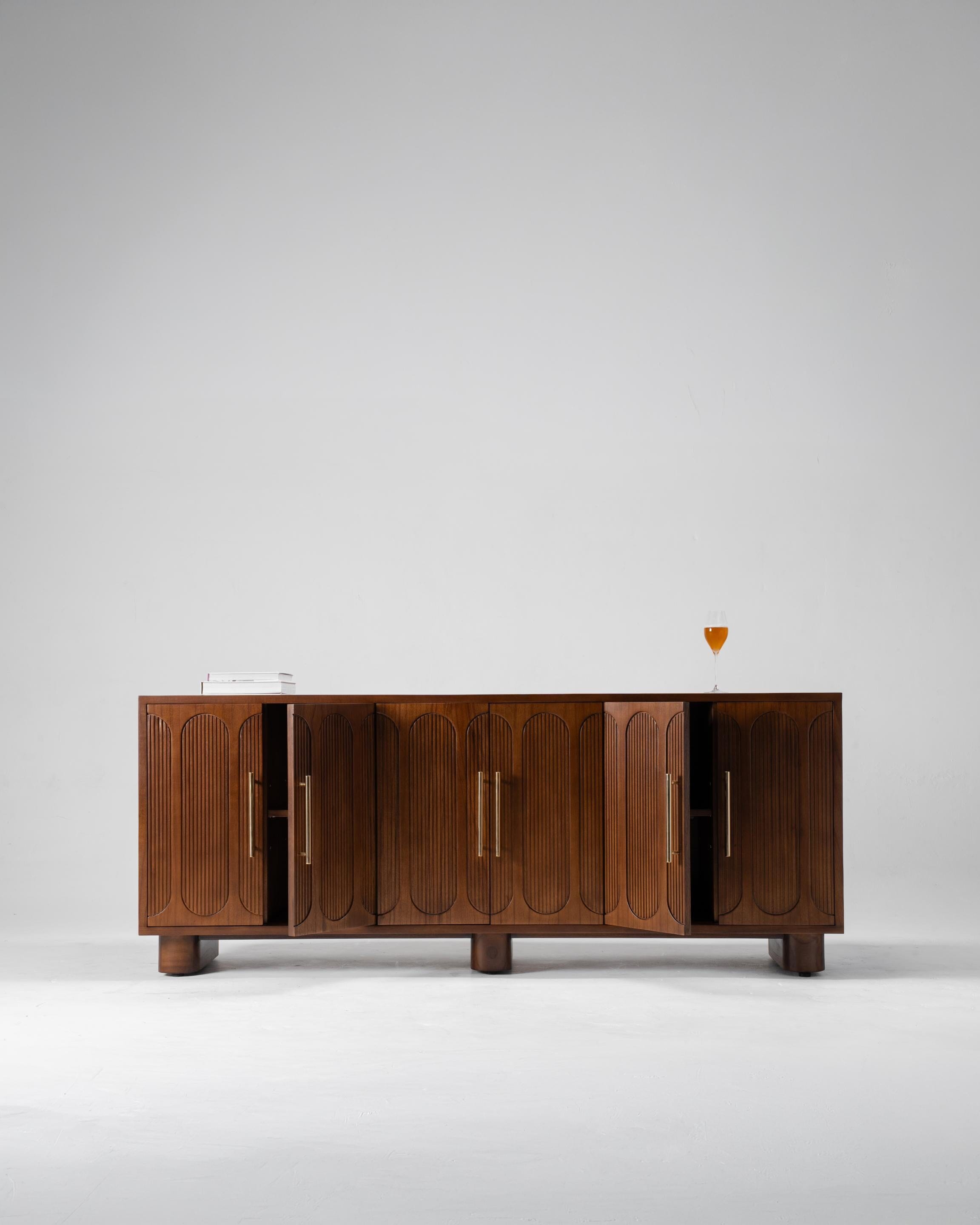 Mid-century modern wooden sideboard cabinet with arched door panels and brass handles
