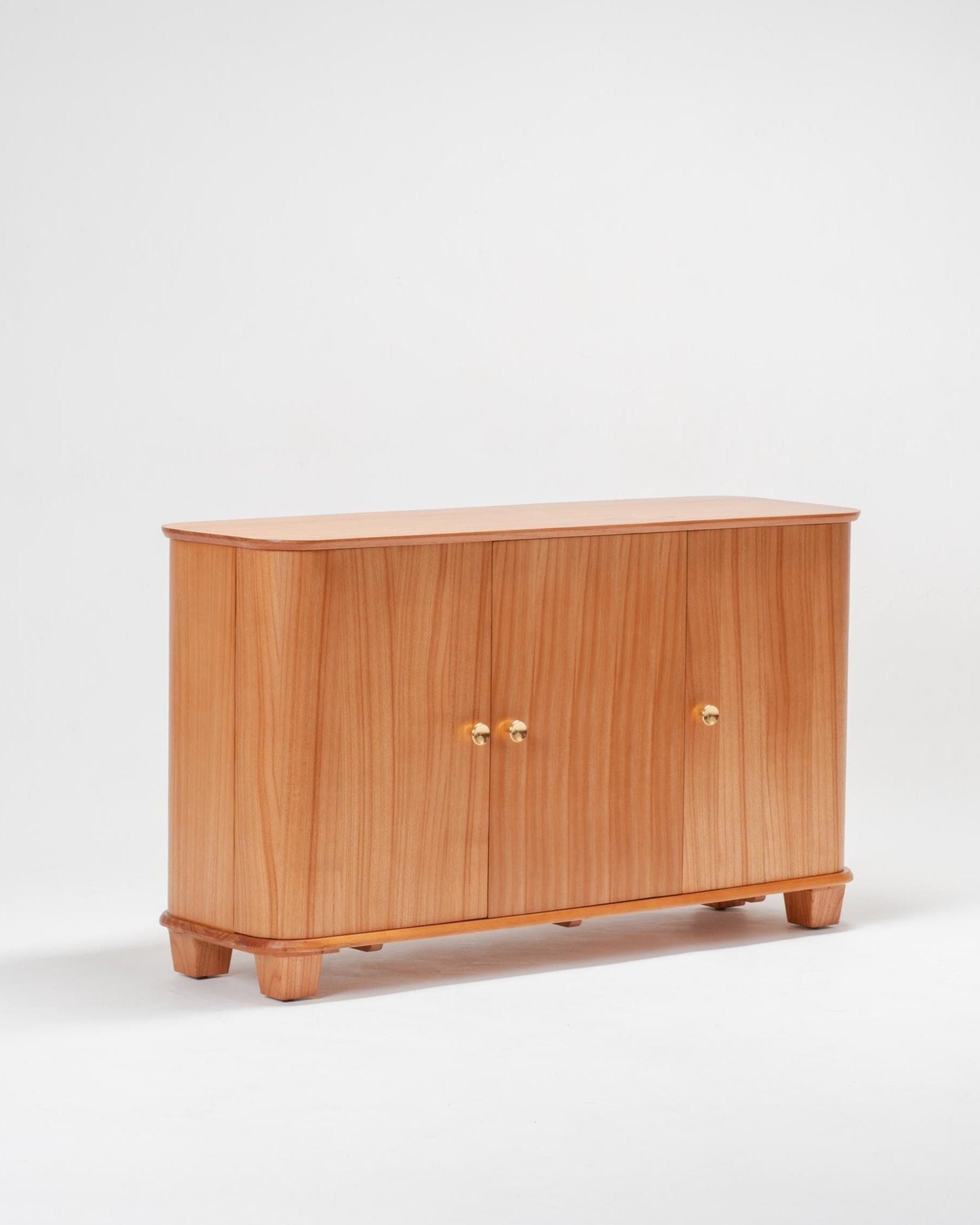 Wooden scandinavian sideboard with three doors on a white background