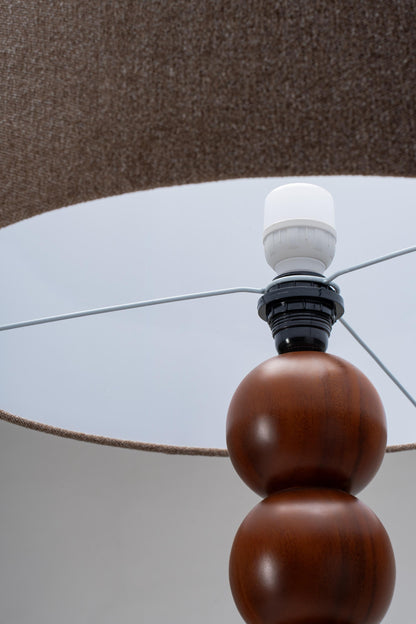 Close-up of a lamp with wooden base and brown lamp shade