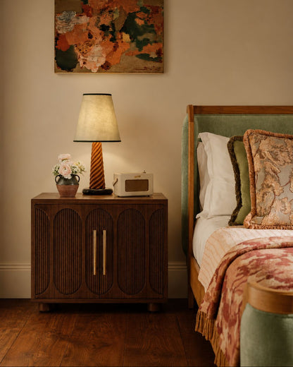 Large dark wood bedside table in a bedroom setting