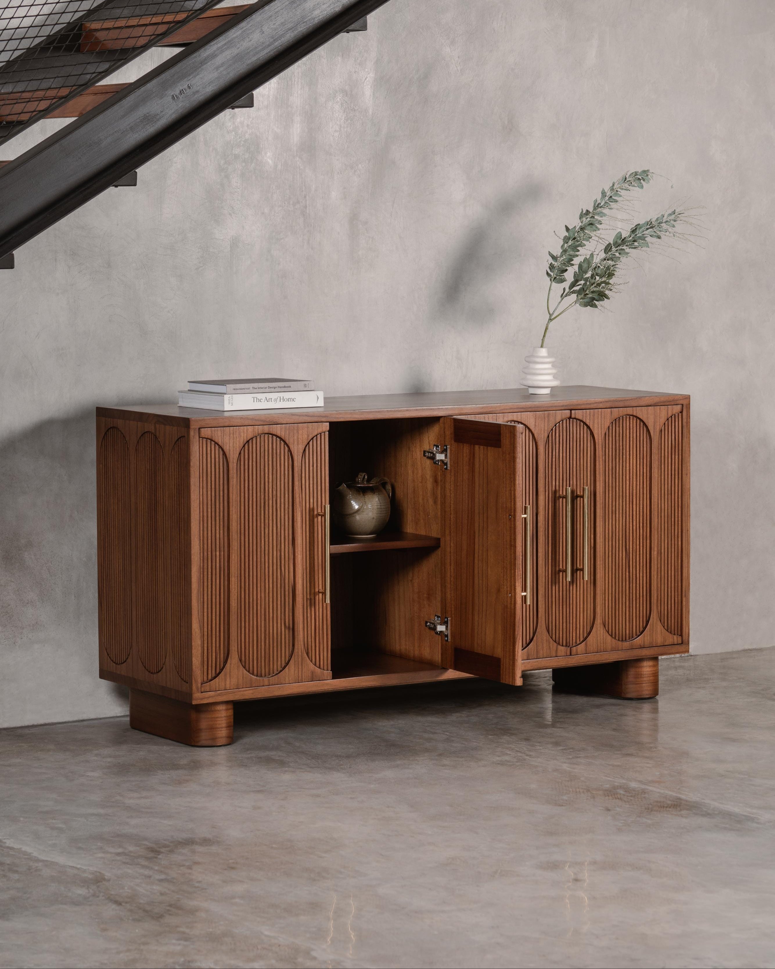 dark wooden sideboard with open door 