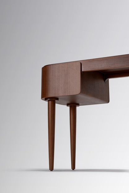 Wooden desk with curved design and thin legs 
