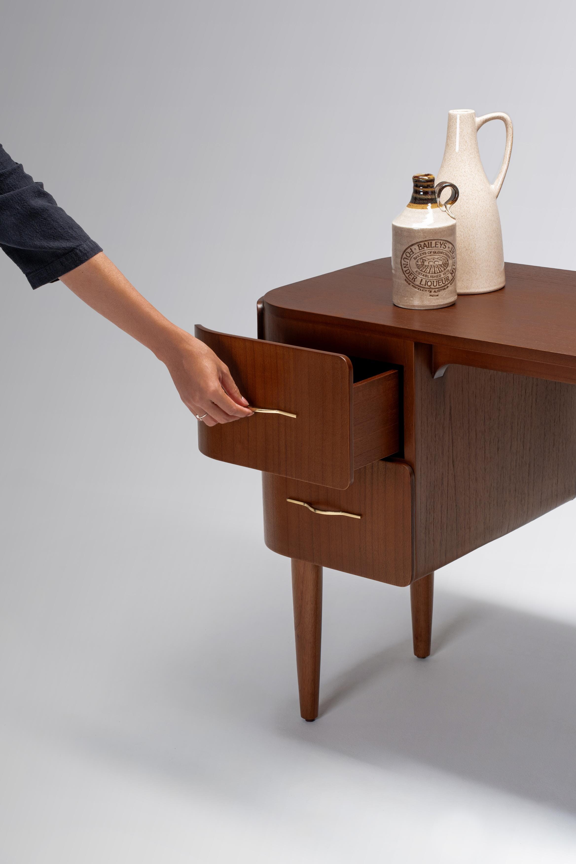 Wooden table with a drawer being opened, on a plain background