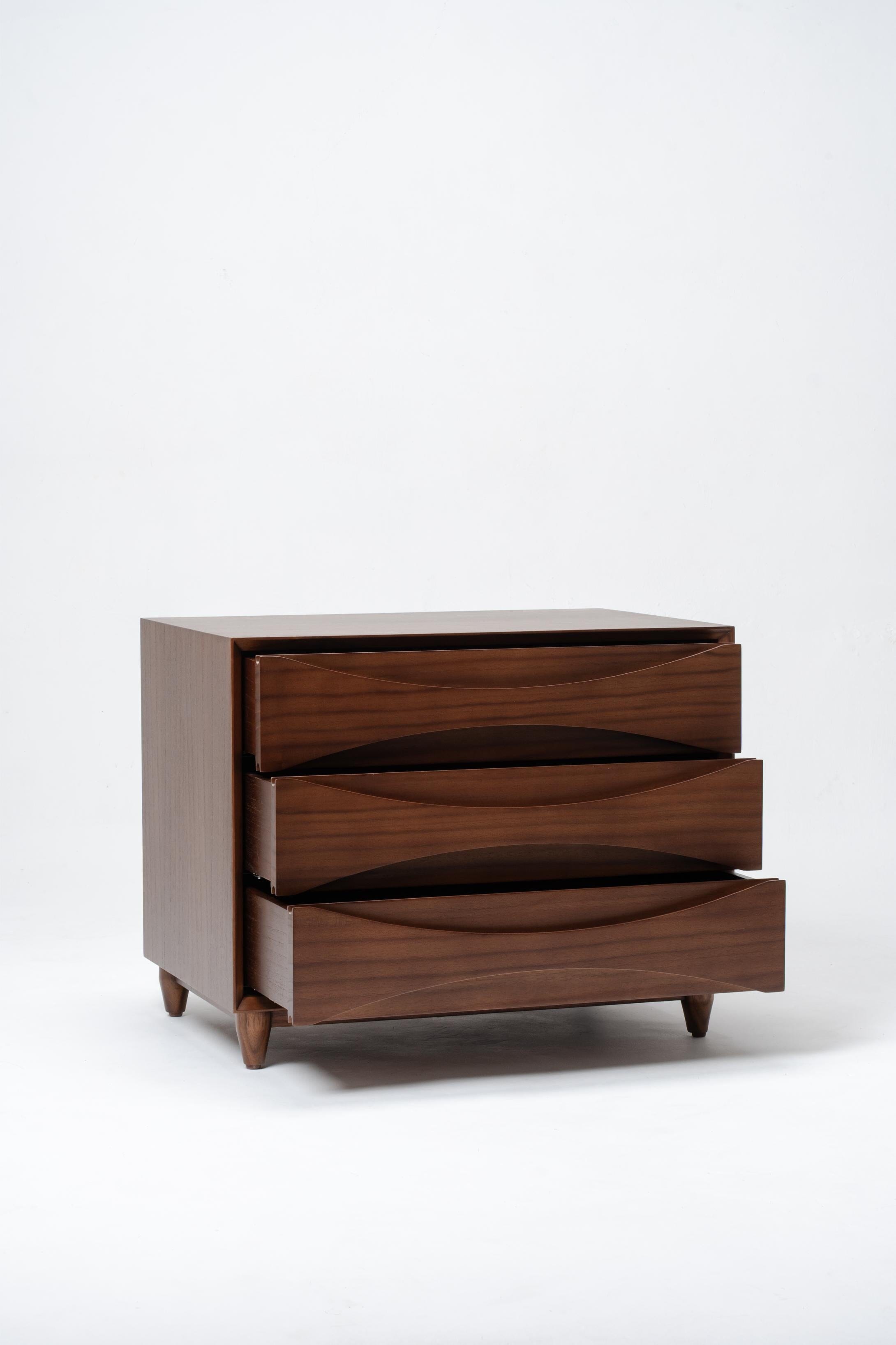 Wooden dresser with three drawers on a white background