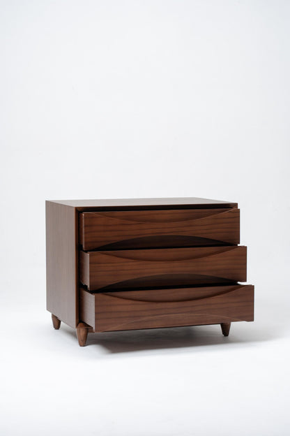 Wooden dresser with three drawers on a white background